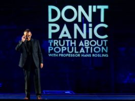 Hans Rosling standing on the stage, presenting Dont Panic - The Truth About Population Sizes