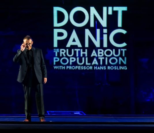 Hans Rosling standing on the stage, presenting Dont Panic - The Truth About Population Sizes