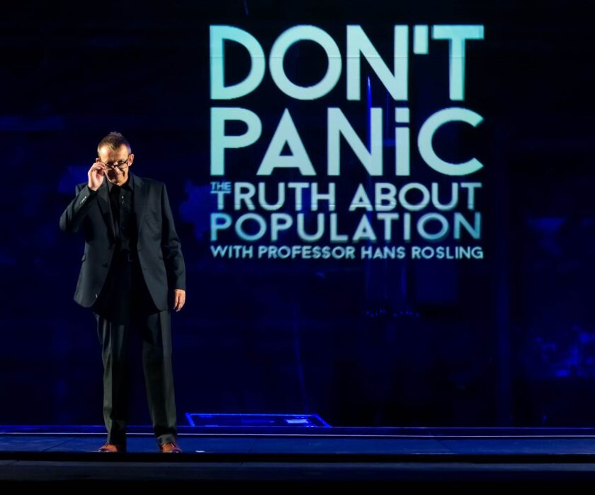 Hans Rosling standing on the stage, presenting Dont Panic - The Truth About Population Sizes